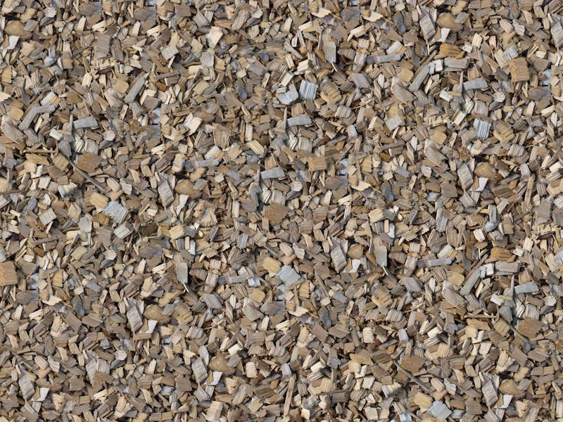 Close-up view of fresh wood chip mulch spread around a tree base in an Alabama yard
